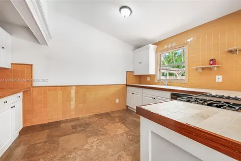 a kitchen that has a sink and a stove