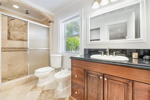 a bathroom with a sink toilet a mirror and shower