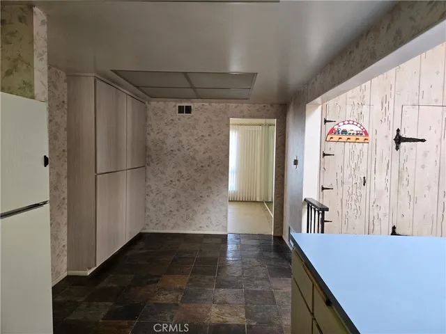 a kitchen with a refrigerator and a sink