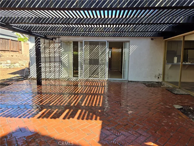 a view of a yard with plants and a large tree