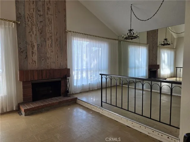 a view of a livingroom with a fireplace and window