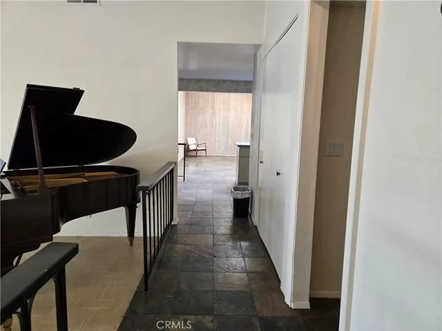 a hallway with sliding door and wooden floors