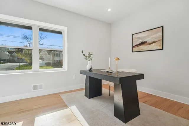 a room with a table and painting on the wall