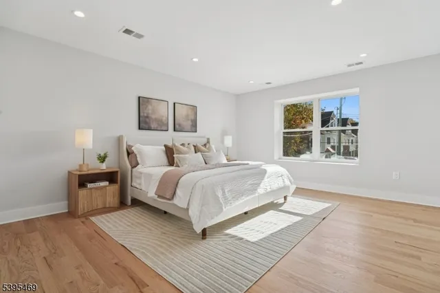 a bedroom with a large bed and a window