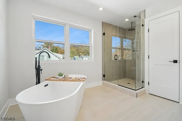 a white bath tub sitting next to a bathroom