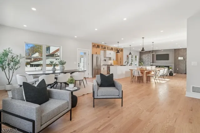 a living room with furniture and view of kitchen