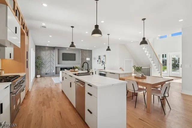 a kitchen with a sink a stove and chairs