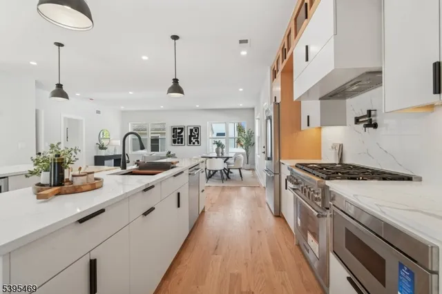 a kitchen with stove a sink and cabinets