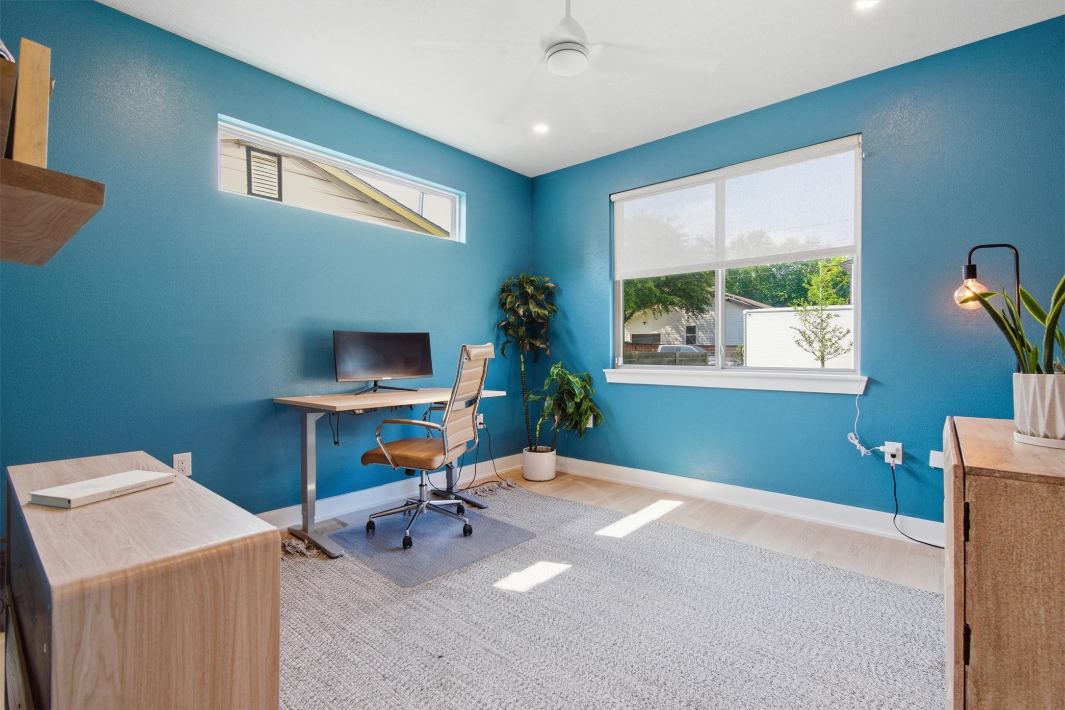 2710 Zaragosa Street, Unit A Austin, TX 78702 - Photo 7 of 29 Blue Suite (Bedroom 1) - Bold blue accent wall and oversized window make this a bright, productive home office or flex space.
