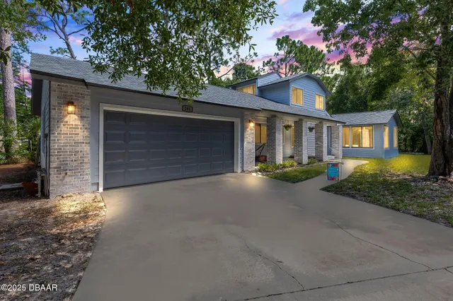 a view of a house with a yard and sitting area