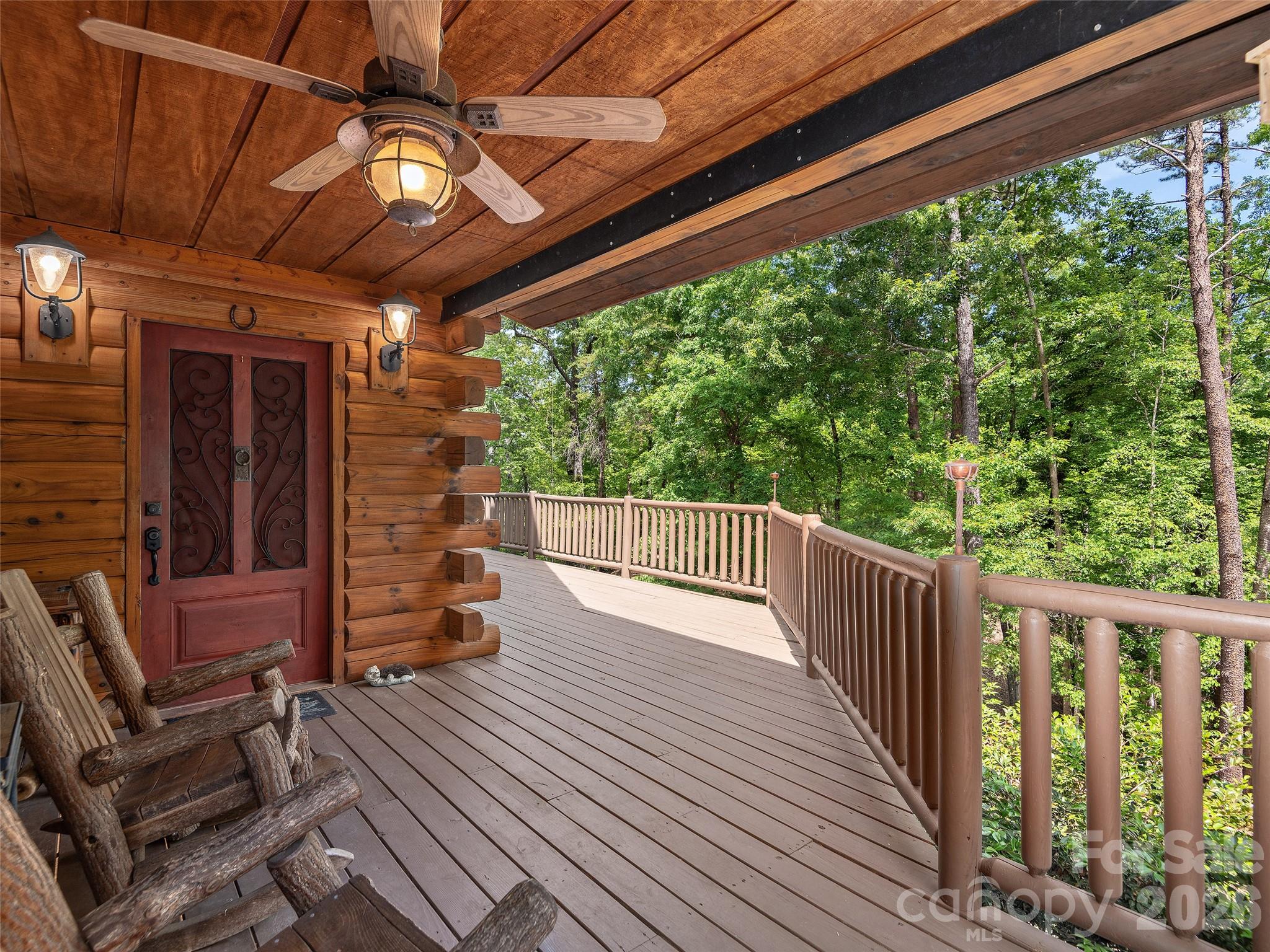 413 Green Hills Road Mill Spring, NC 28756 - Photo 4 of 48 a view of a porch with wooden floor