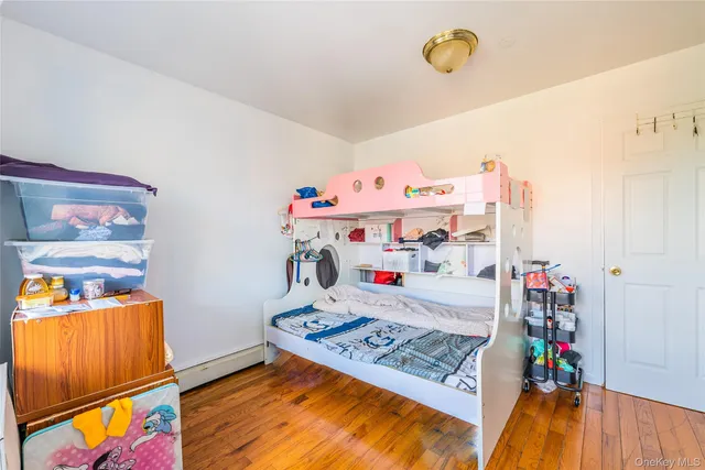 an empty room with window and wooden floor