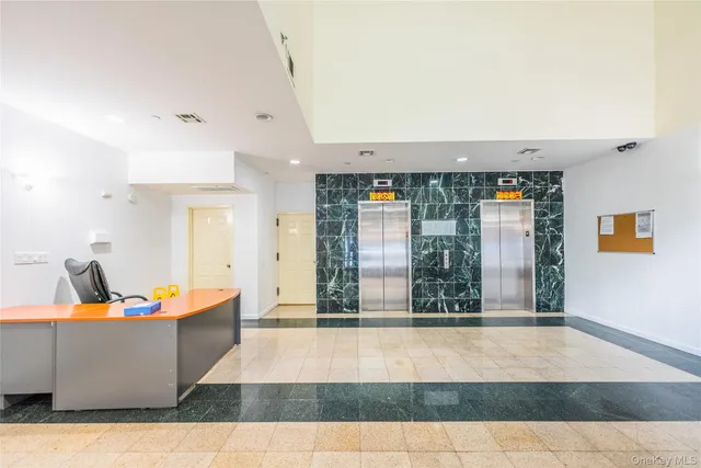 a living room with furniture and large windows