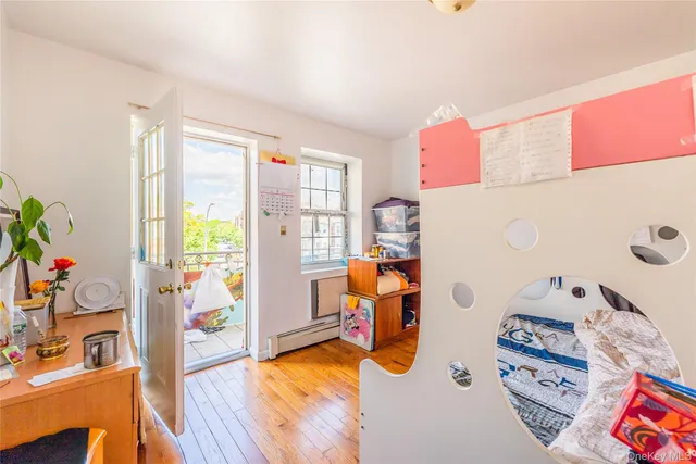 a bedroom with furniture and a wooden floor