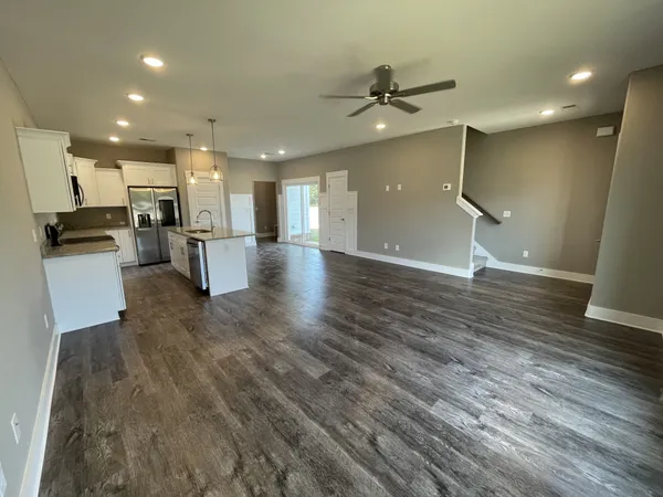 a view of a kitchen and a refrigerator