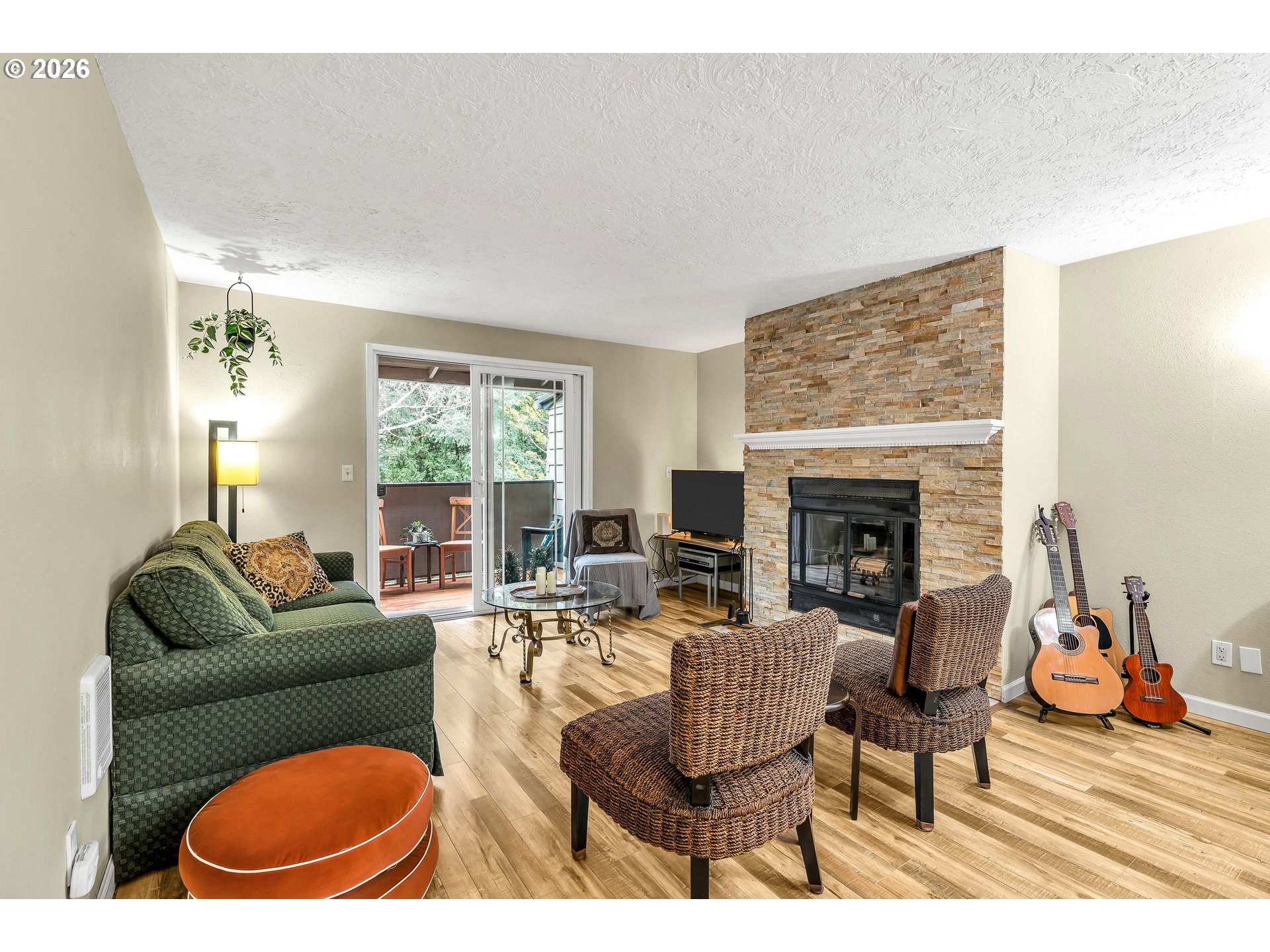 29700 Southwest Courtside Drive, Unit 36 Wilsonville, OR 97070 - Photo 12 of 40 a living room with furniture a fireplace and a large window