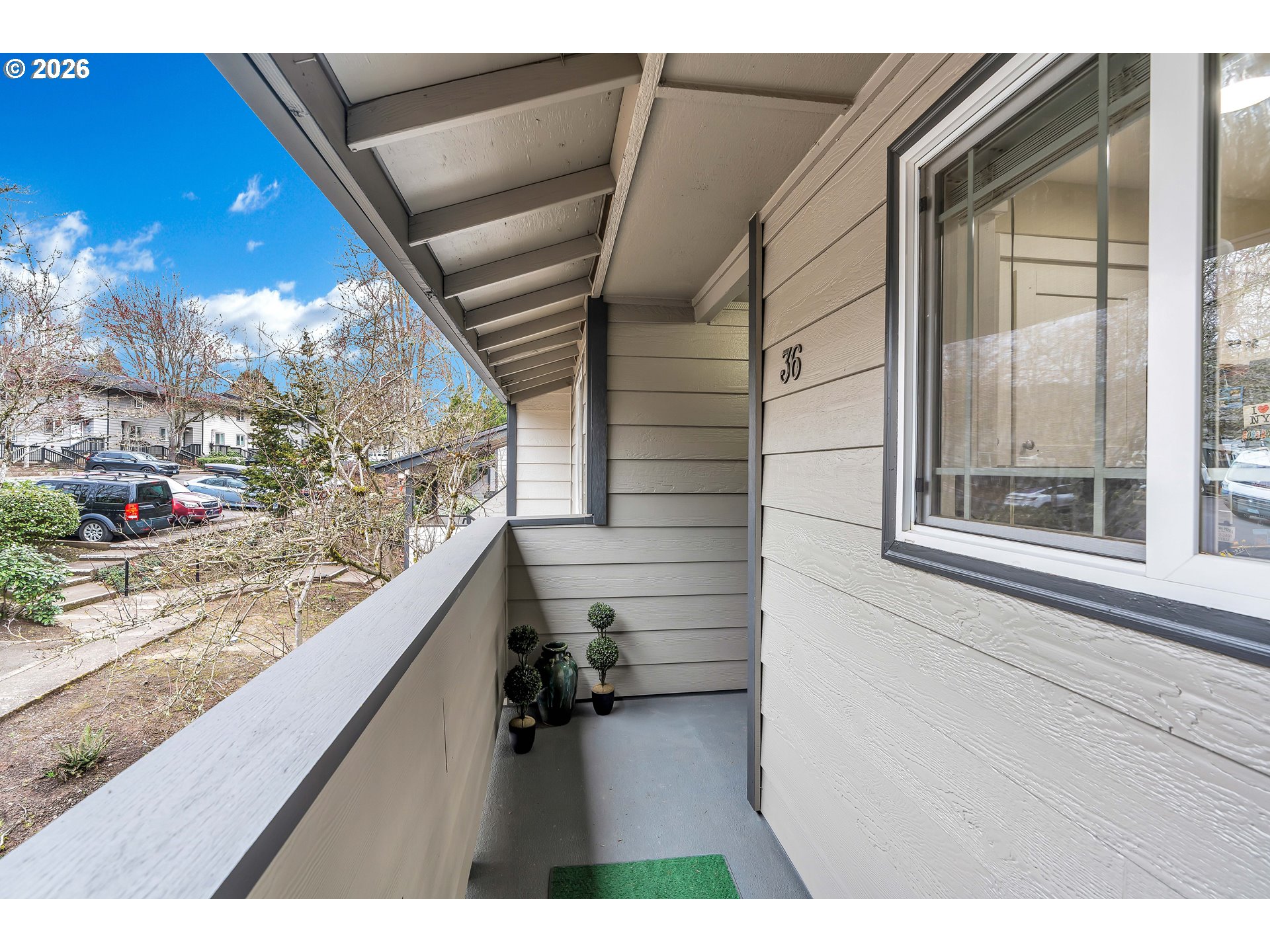 29700 Southwest Courtside Drive, Unit 36 Wilsonville, OR 97070 - Photo 4 of 40 a view of a porch with a bench