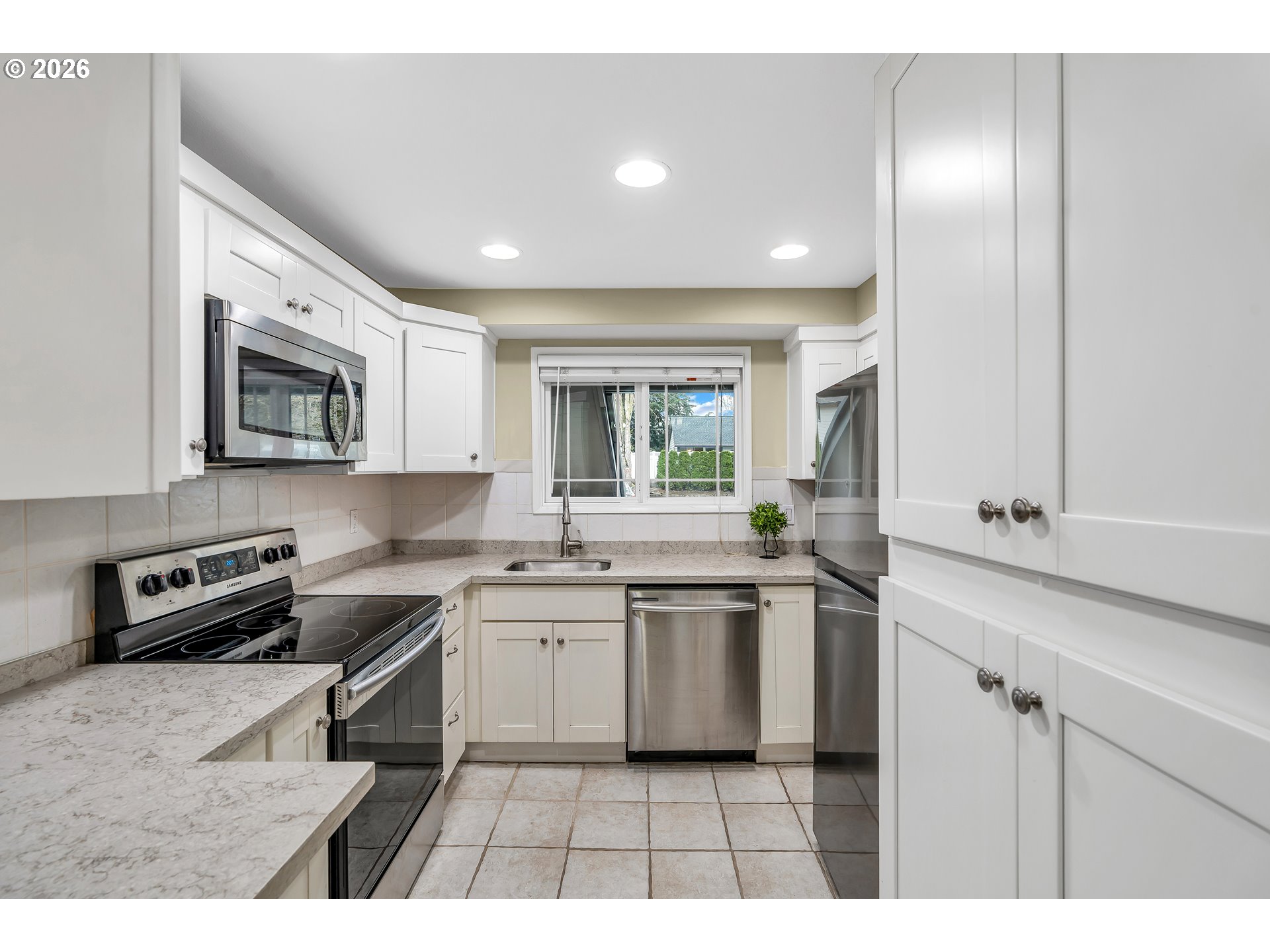 29700 Southwest Courtside Drive, Unit 36 Wilsonville, OR 97070 - Photo 7 of 40 a open kitchen with stainless steel appliances a sink stove and cabinets