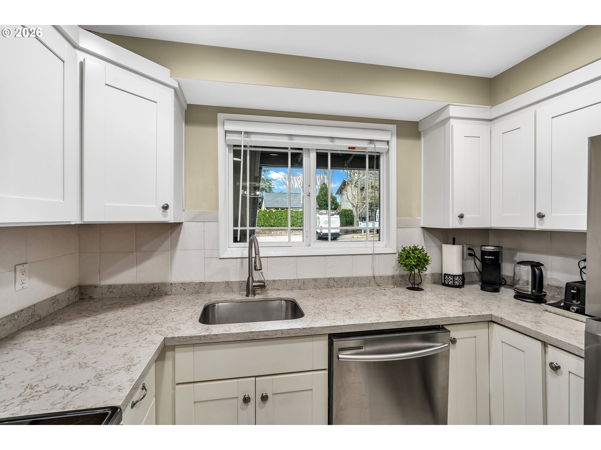 29700 Southwest Courtside Drive, Unit 36 Wilsonville, OR 97070 - Photo 8 of 40 a kitchen with stainless steel appliances granite countertop a sink and a white cabinets