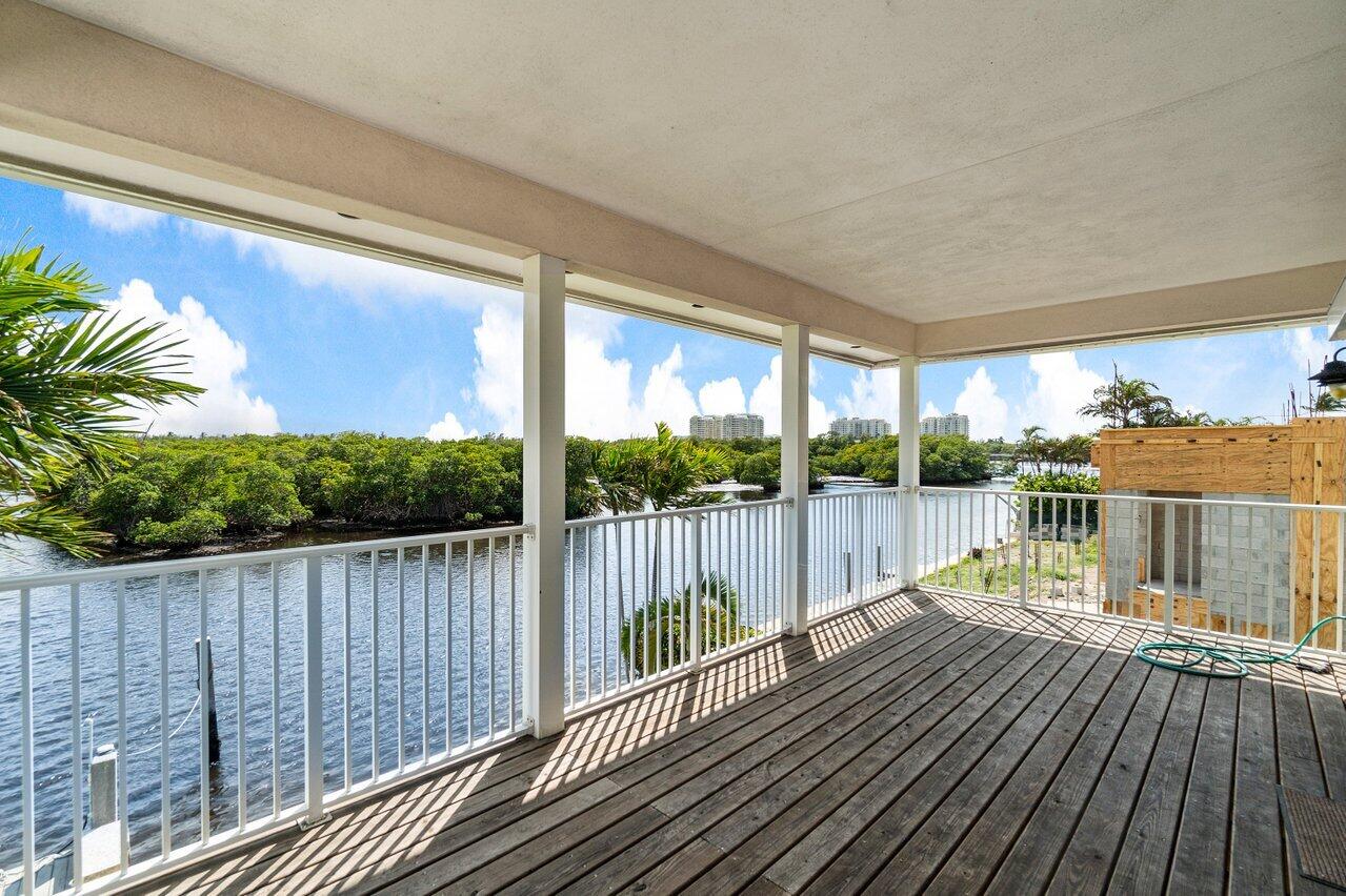 2 Inlet Cay Drive Ocean Ridge, FL 33435 - Photo 14 of 22 a balcony with wooden floor and outdoor space