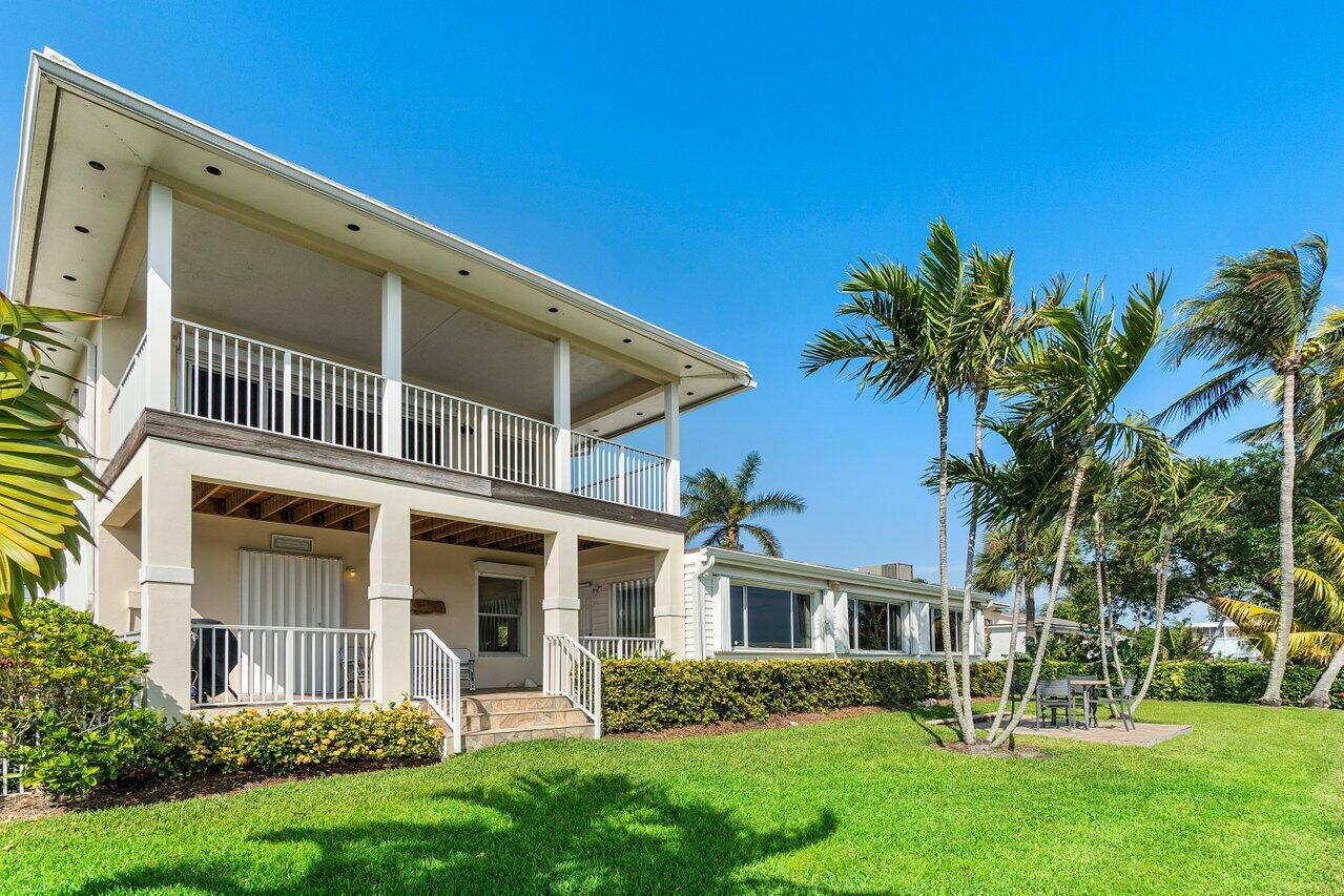 2 Inlet Cay Drive Ocean Ridge, FL 33435 - Photo 18 of 22 front view of a house with a yard