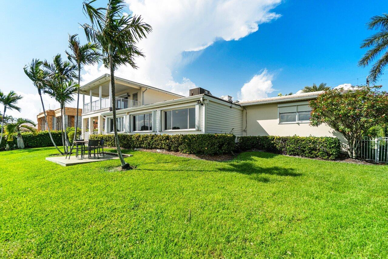 2 Inlet Cay Drive Ocean Ridge, FL 33435 - Photo 19 of 22 a front view of house with yard and green space