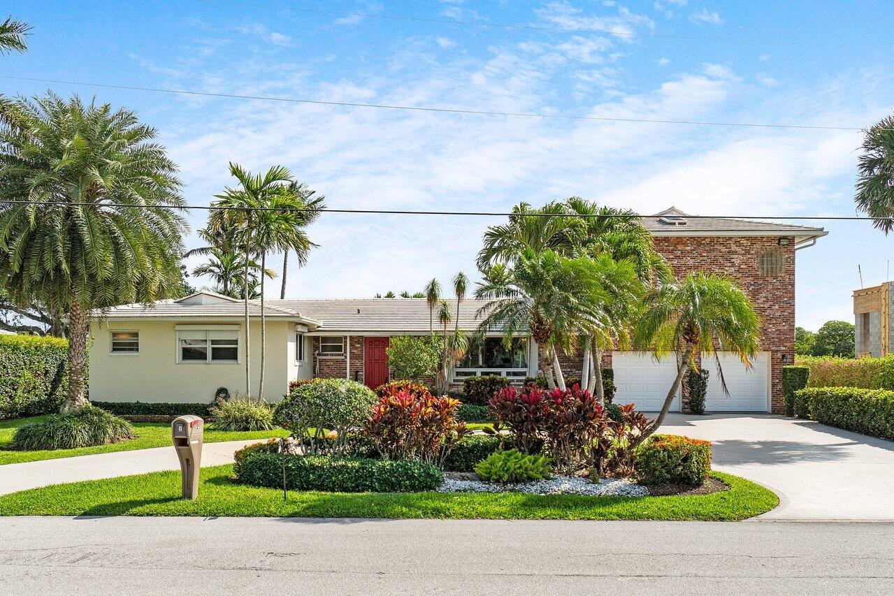 2 Inlet Cay Drive Ocean Ridge, FL 33435 - Photo 7 of 22 a front view of a house with garden