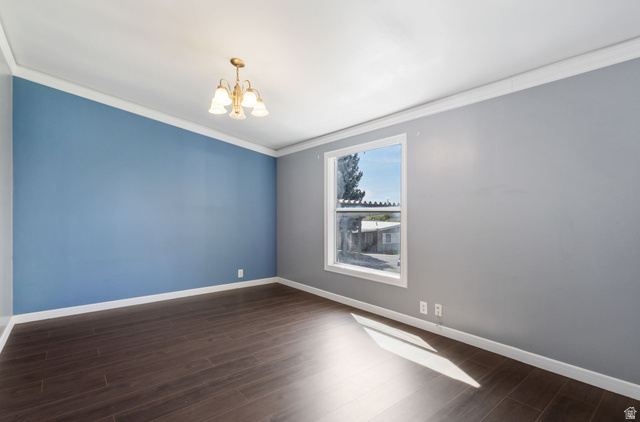 2600 North Hill Field Road, Unit 86 Layton, UT 84041 - Photo 16 of 25 Empty room featuring ornamental molding, suspended lighting, and dark wood-style flooring