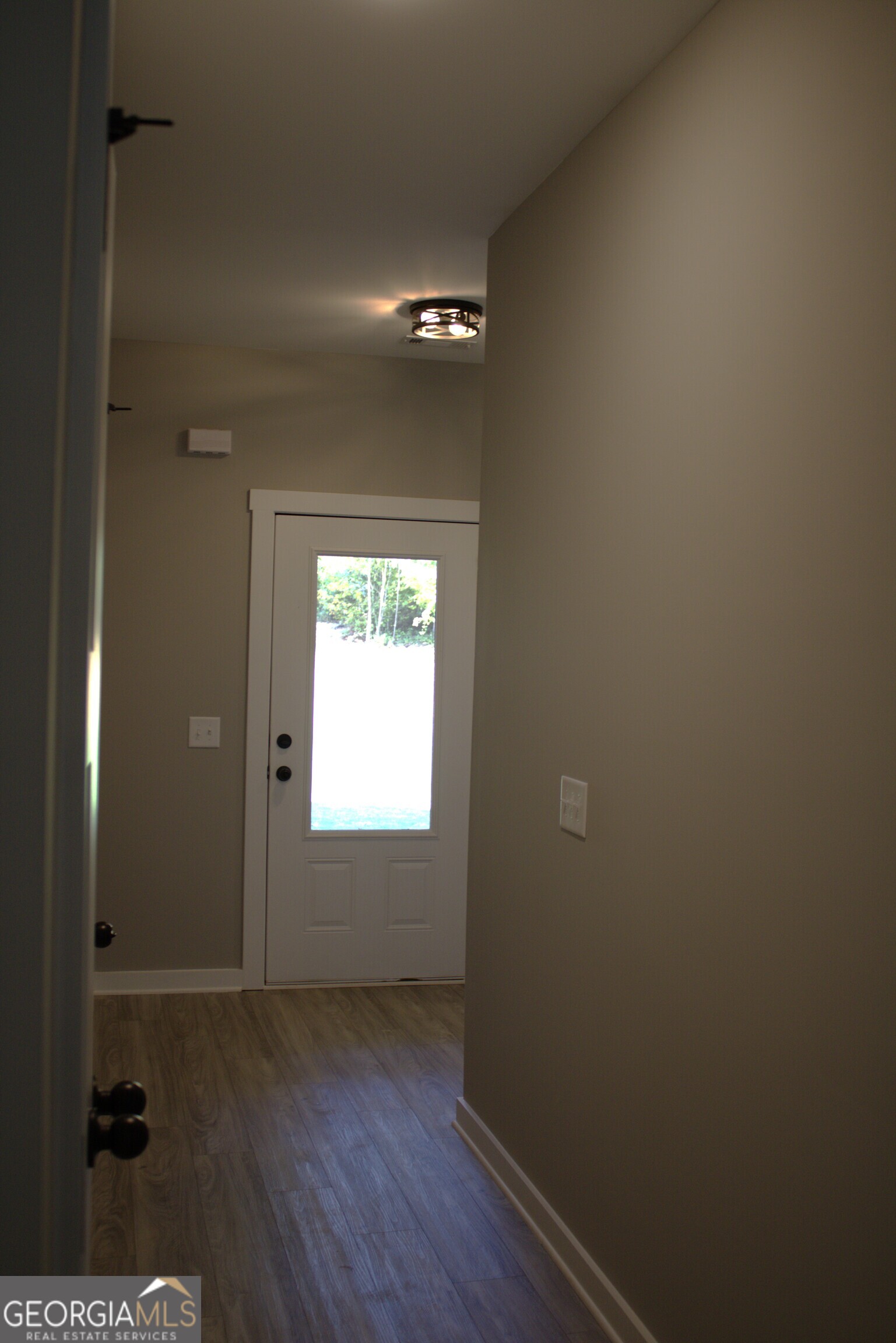 247 North Point Circle Hartwell, GA 30643 - Photo 10 of 18 a view of an empty room with wooden floor and a window