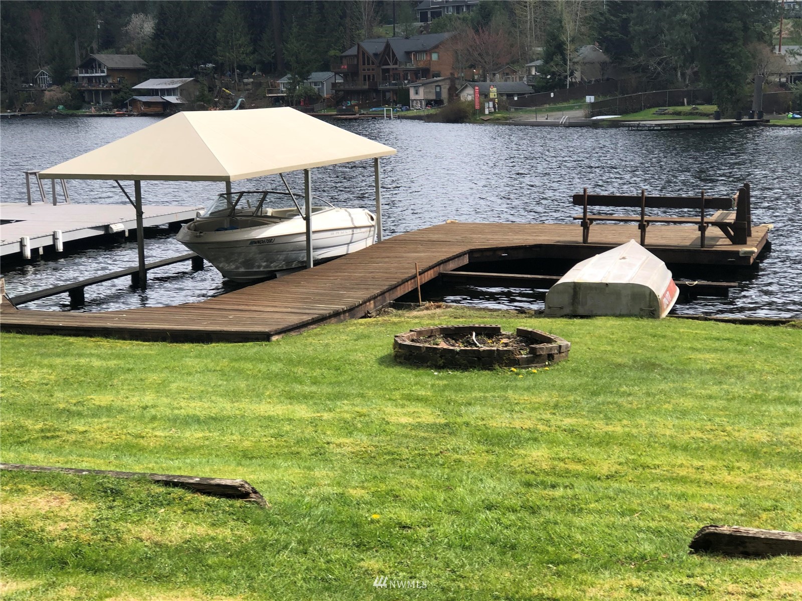 2709 Southwest Lake Roesiger Road Snohomish, WA 98290 - Photo 7 of 10 a view of a swimming pool with lawn chairs under an umbrella