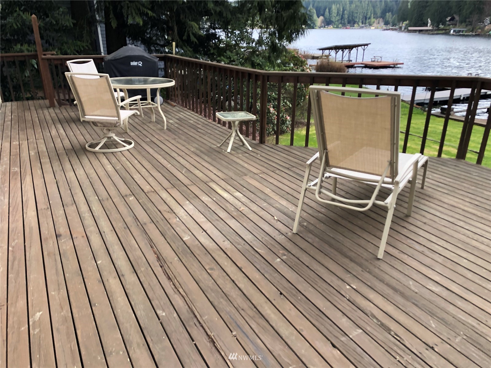 2709 Southwest Lake Roesiger Road Snohomish, WA 98290 - Photo 8 of 10 a roof deck with table and chairs and wooden floor