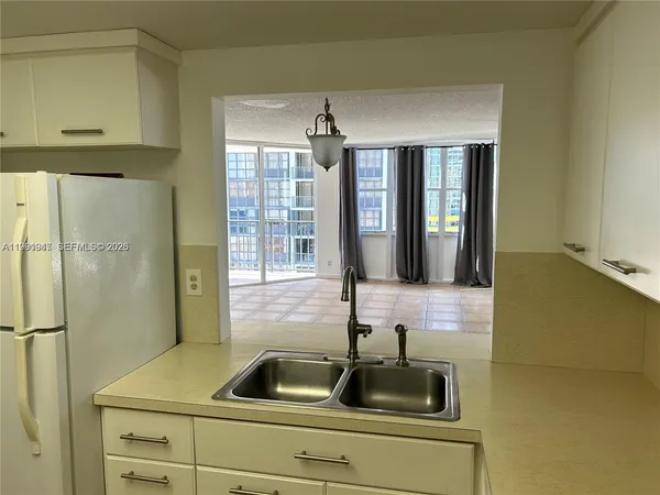 a bathroom with a granite countertop sink and a toilet