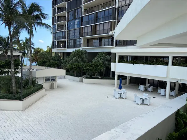 a view of a swimming pool with outdoor seating and a potted plants