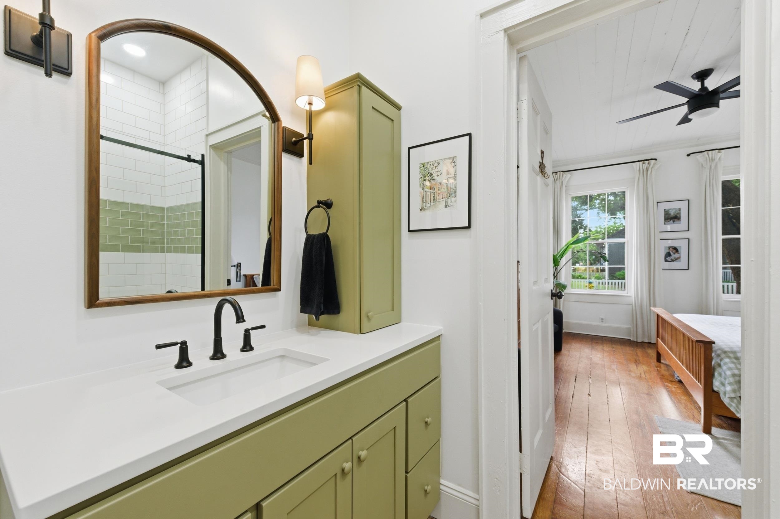 350 Charles Street Mobile, AL 36604 - Photo 20 of 52 Bathroom vanity featuring a matte black widespread faucet, integrated rectangular sink, and white countertop
