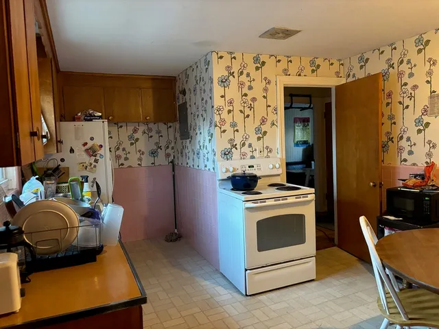 a kitchen with stainless steel appliances kitchen island granite countertop a stove and a refrigerator