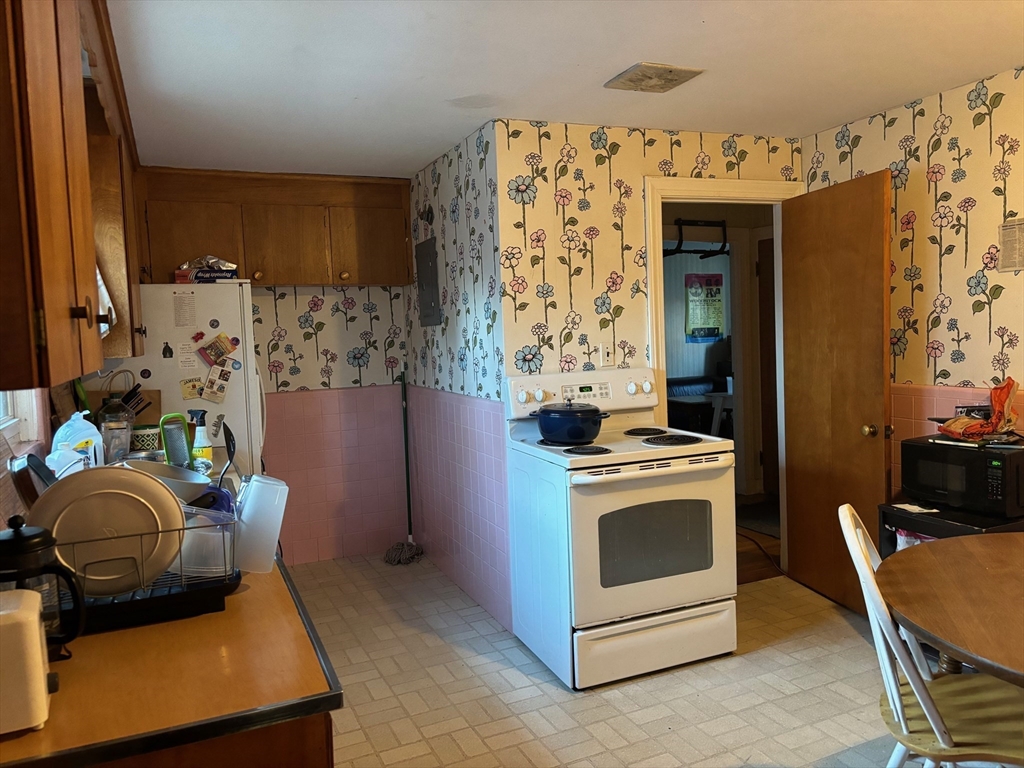 16 Caltha Road Boston, MA 02135 - Photo 5 of 13 a kitchen with stainless steel appliances kitchen island granite countertop a stove and a refrigerator