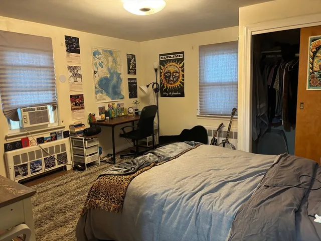 a bedroom with a bed and wooden furniture
