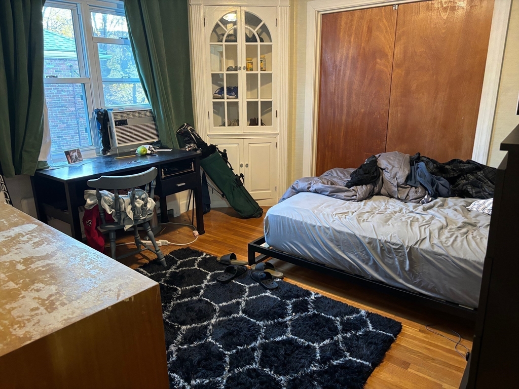 16 Caltha Road Boston, MA 02135 - Photo 8 of 13 a bedroom with a bed and wooden floor