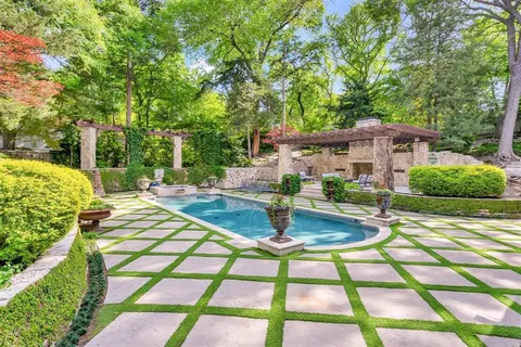 a swimming pool with barbeque oven and outdoor seating