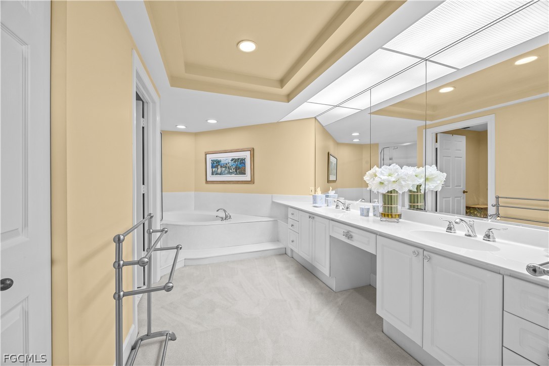 2619 Wulfert Road, Unit 3 Sanibel, FL 33957 - Photo 11 of 42 a bathroom with a double vanity sink mirror and bathtub