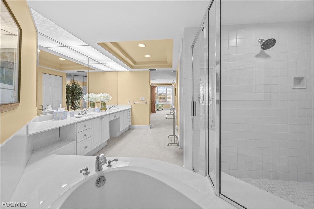 2619 Wulfert Road, Unit 3 Sanibel, FL 33957 - Photo 12 of 42 a large bathroom with a tub sink shower and mirror