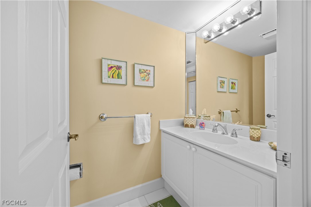 2619 Wulfert Road, Unit 3 Sanibel, FL 33957 - Photo 18 of 42 a bathroom with a sink mirror and vanity