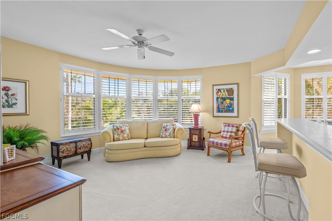 2619 Wulfert Road, Unit 3 Sanibel, FL 33957 - Photo 25 of 42 a living room with furniture and floor to ceiling windows