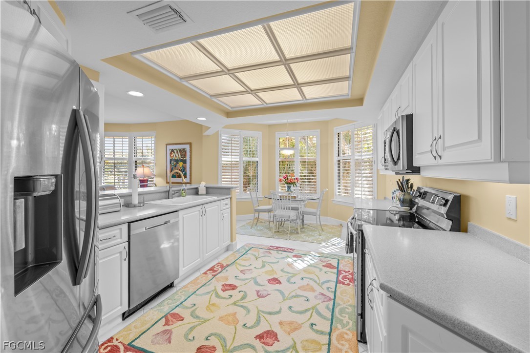 2619 Wulfert Road, Unit 3 Sanibel, FL 33957 - Photo 30 of 42 a large kitchen with stainless steel appliances granite countertop a sink and cabinets