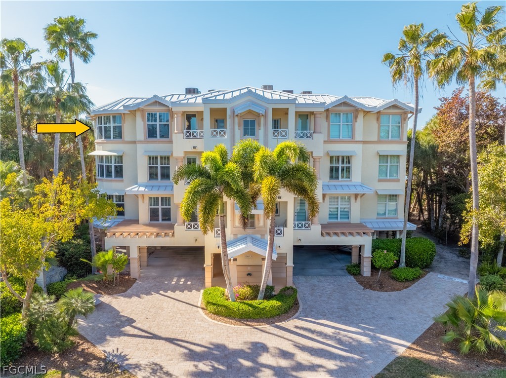 2619 Wulfert Road, Unit 3 Sanibel, FL 33957 - Photo 42 of 42 a front view of a multi story residential apartment building with yard and parking