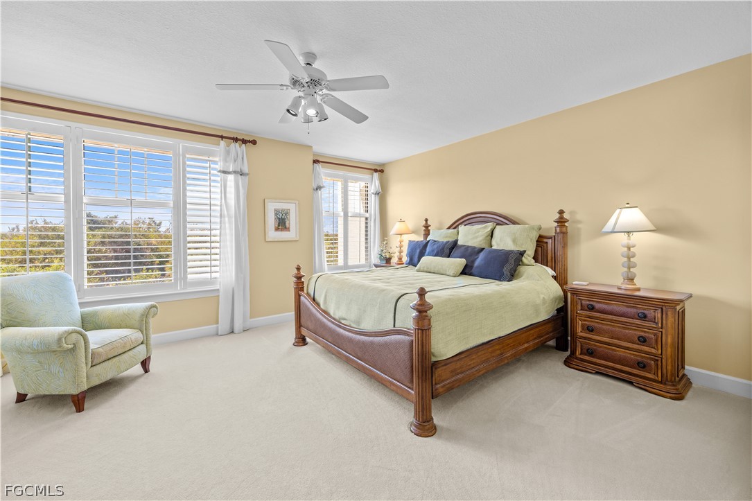 2619 Wulfert Road, Unit 3 Sanibel, FL 33957 - Photo 7 of 42 a bedroom with a bed and a chandelier