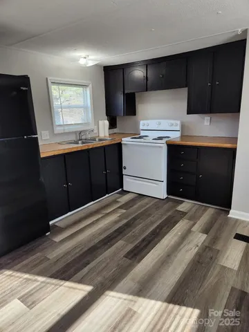 a kitchen with a sink stove and refrigerator