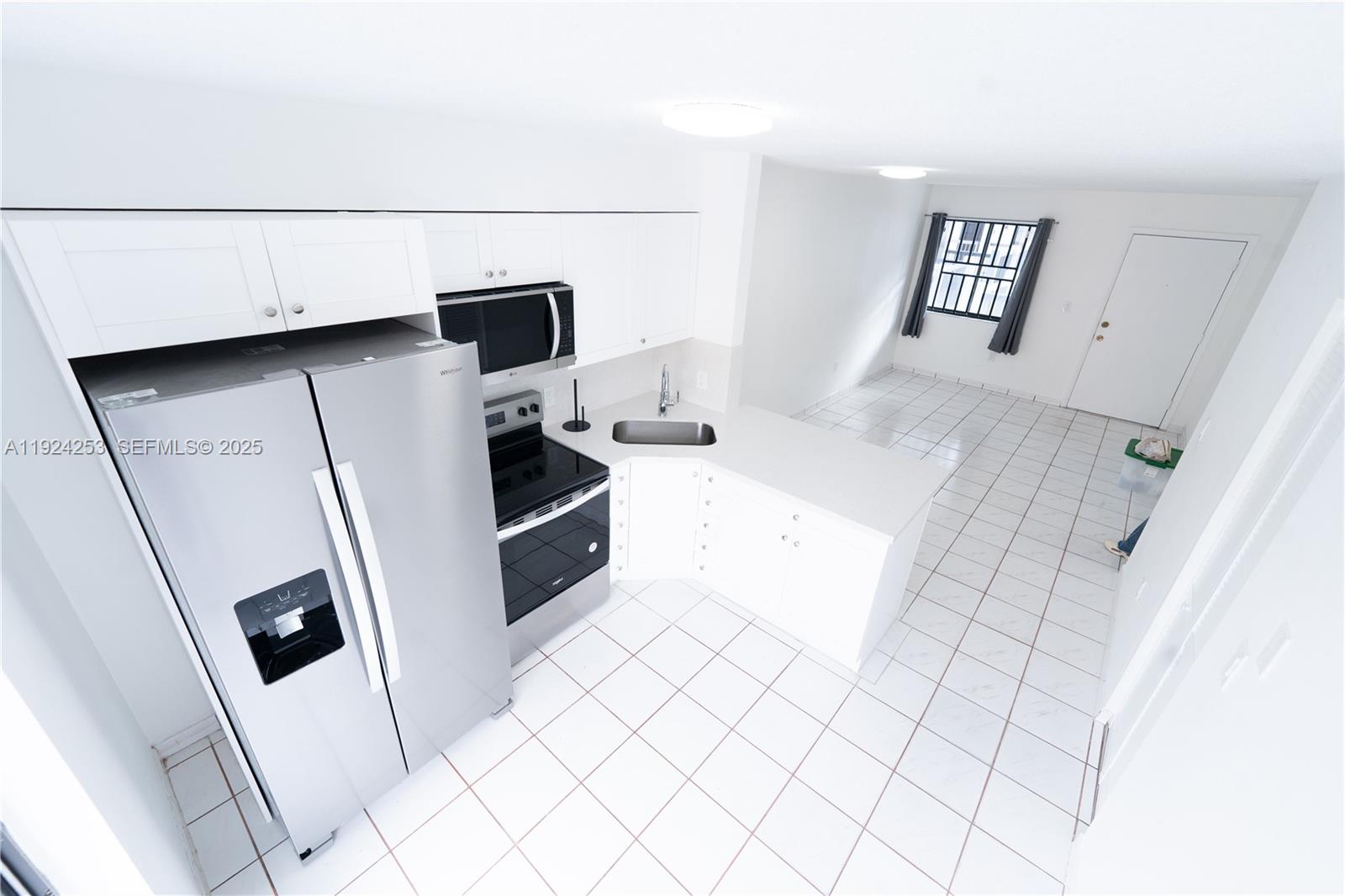 5300 West 21st Court, Unit 311 Hialeah, FL 33016 - Photo 2 of 10 a kitchen with stainless steel appliances a refrigerator and a stove top oven