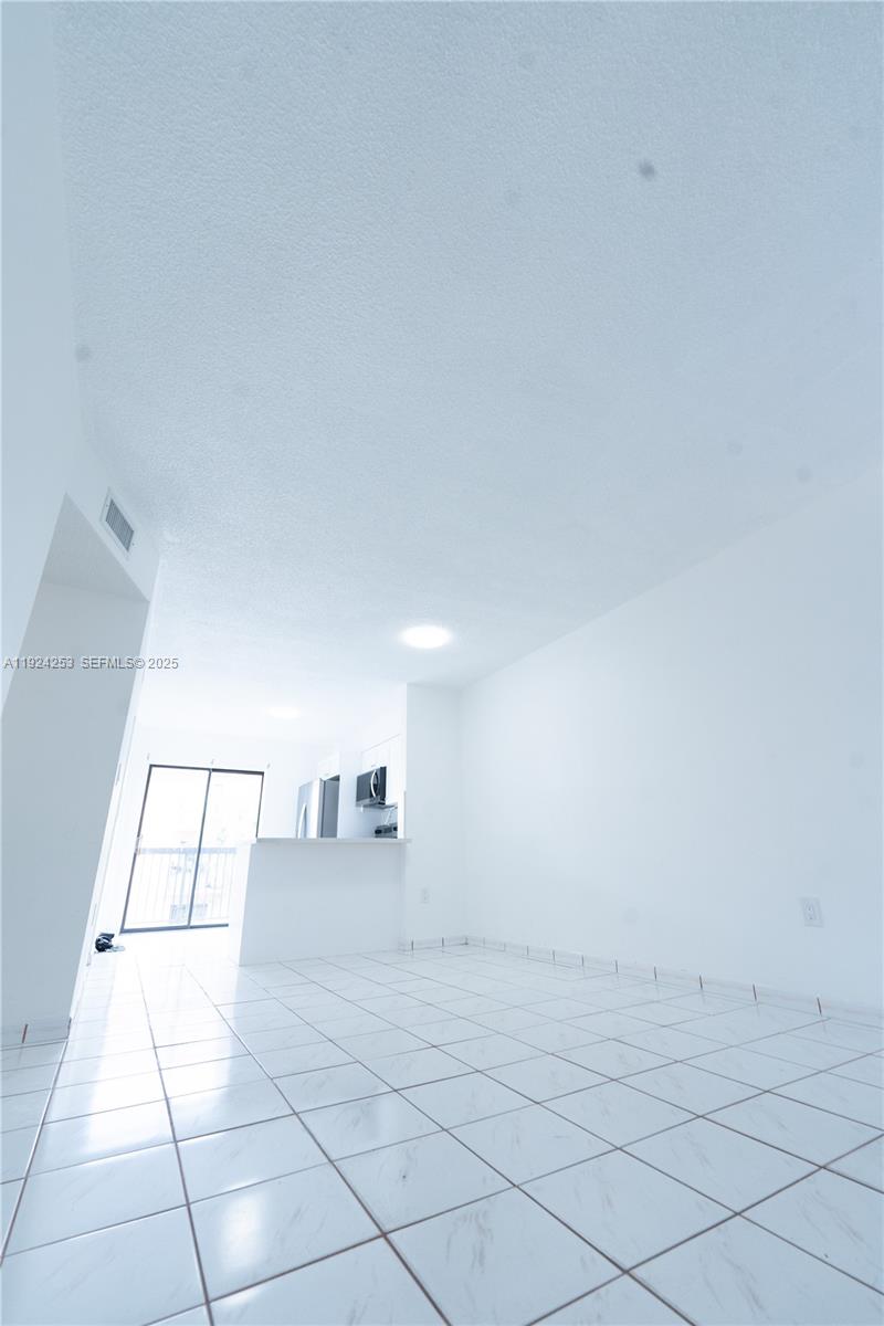 5300 West 21st Court, Unit 311 Hialeah, FL 33016 - Photo 5 of 10 a view of an empty room and window