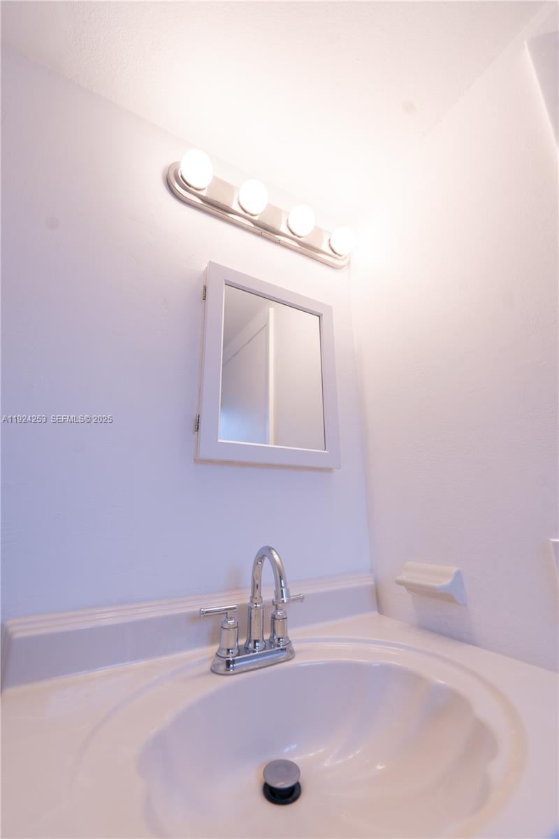 5300 West 21st Court, Unit 311 Hialeah, FL 33016 - Photo 7 of 10 a bathroom with a sink and a mirror